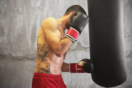 Boxer man doing exercise with punching bagのeditorial素材