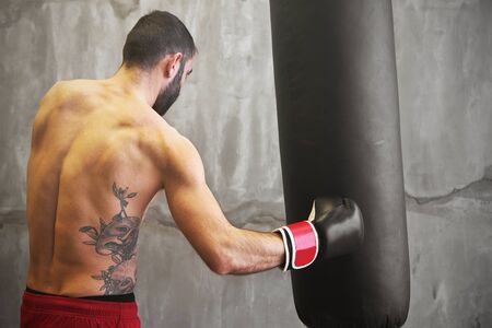 Boxer man doing exercise with punching bagのeditorial素材