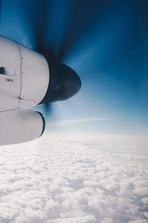 Propeller plane in air above the cloudsの写真素材