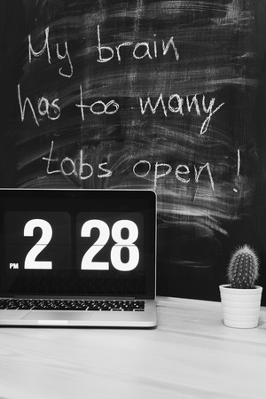 Workplace with table and written blackboardの写真素材