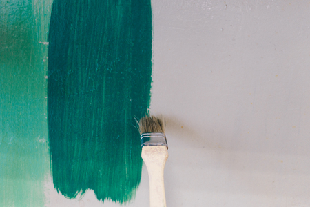 Mans hand painting wall in greenの写真素材