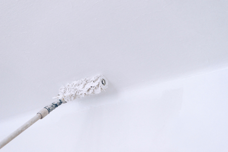Close up details of painting walls with white colorの写真素材