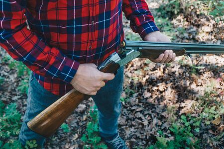 Hunter with a gun  on the forestの写真素材