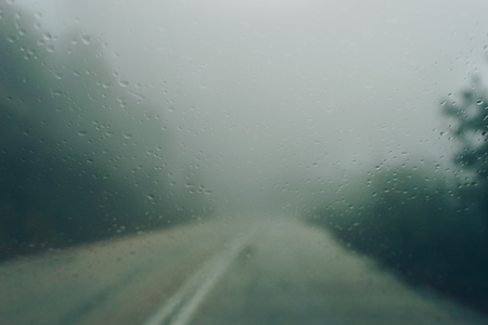 Autumn landscape, foggy road in forestの写真素材