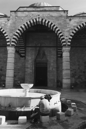 Ablution taps where a man washing his self before prayer time. Edirne Turkey.の写真素材