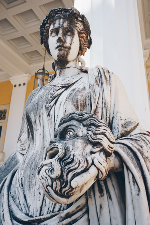 Statue of Melpomene, the muse of tragedy holding a tragic mask, on Achillion palace, Corfu Greece.のeditorial素材