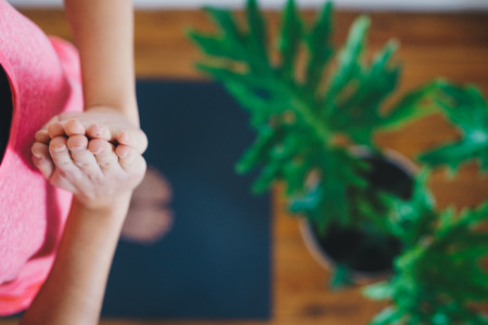 Young woman doing yoga in the morning at her home, top viewの写真素材