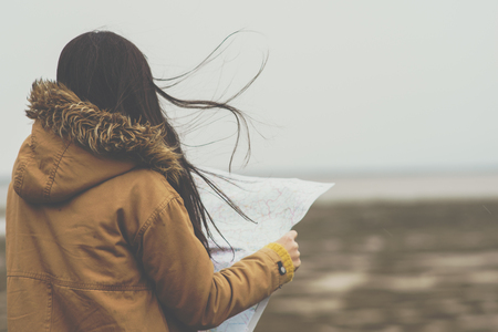 Woman reading a map next to a river, Greece.の写真素材