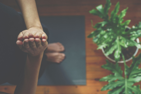 Young woman doing yoga in the morning at her home, top viewの写真素材