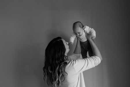 Picture of happy mother playing with her baby 