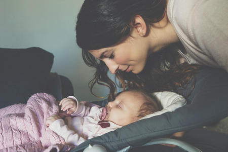 Mother is taking care of her baby.の写真素材
