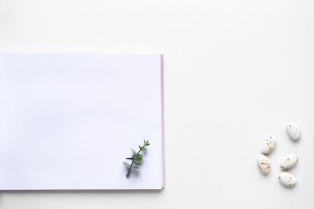 Wedding wish book, candy and oregano branches on white marble. Top viewの写真素材