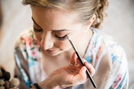Makeup artist preparing bride before the wedding.の写真素材