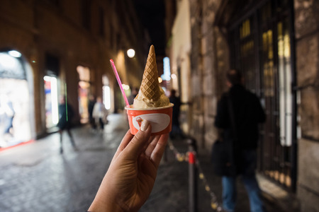 Woman hand holding a cup of Italien ice creamの写真素材