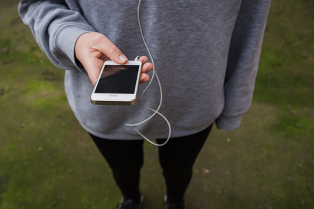 Young woman using wearable tech during fitness workoutの写真素材
