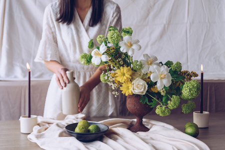 Woman holding bottle. Still life with flower conceptの写真素材