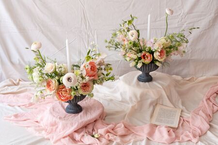 Still life with  beautiful bouquets of flowers and candles の写真素材