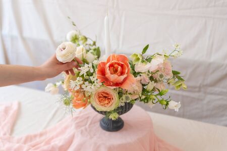 Woman hands touching  a bouquet of flowers.の写真素材