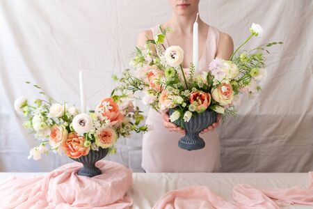 Woman holding vase full of flowers.の写真素材