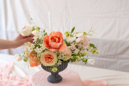 Woman hands touching  a bouquet of flowers.の写真素材