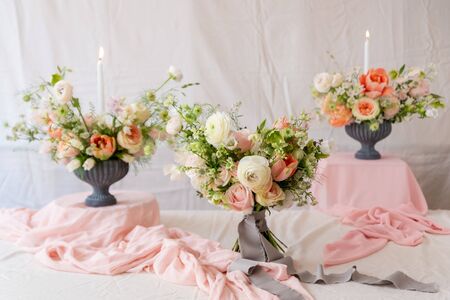 Still life with  beautiful bouquets of flowers and candlesの写真素材