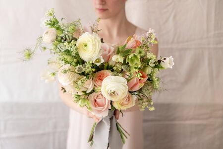Woman holding a bouquet of flowers.の写真素材