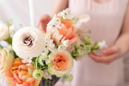 Woman hands touching  a bouquet of flowers.の写真素材