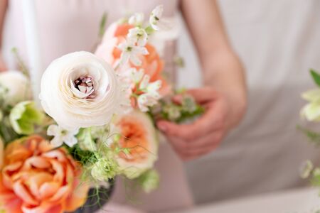 Woman hands touching  a bouquet of flowers.の写真素材