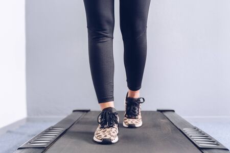 Fitness girl running on treadmill.