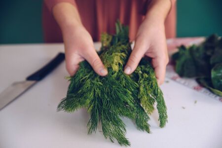 Woman holding  dill leaves