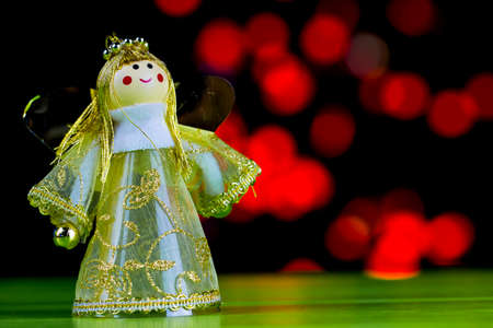 Fairy on a wooden green and red  light bulbの写真素材