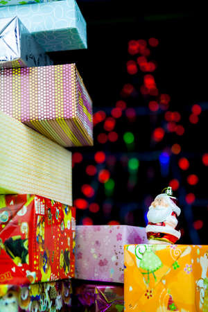 Christmas gift and Santa Claus with blurred light on background