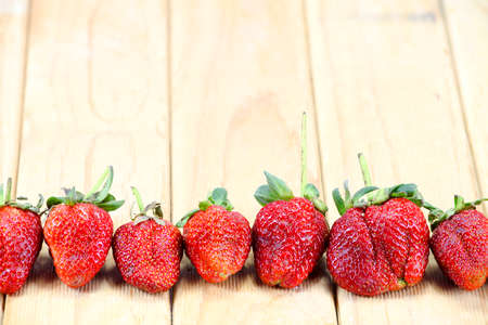 Fresh strawberries on old wooden backgroundの写真素材