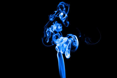 Studio shot of Smoke image on black background and change the color of smoke by a computer program.の写真素材