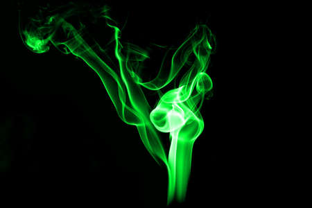 Fire and smoke isolated with light on black backgroundの写真素材