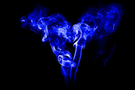 Fire and smoke isolated with light on black backgroundの写真素材