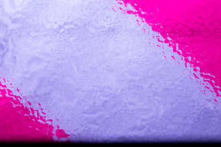 Oil and water droplets on a colorful background.の写真素材