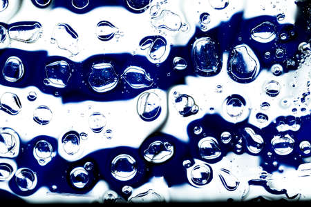 Oil and water droplets on a colorful background.