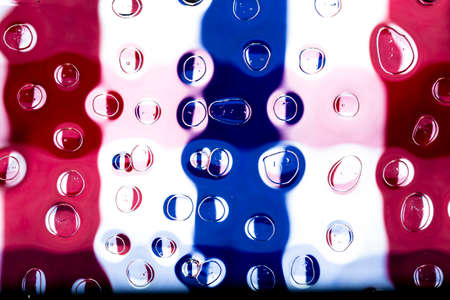 Oil and water droplets on a colorful background.の写真素材