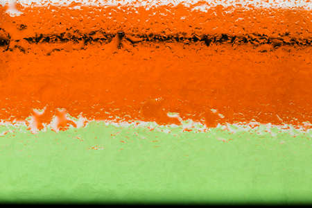 Oil and water droplets on a colorful background.の写真素材