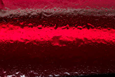 Oil and water droplets on a colorful background.