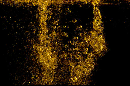 Olive oil is poured into water, shot in the studio.