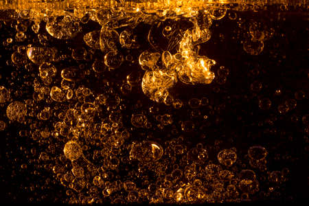 Palm oill is poured into water, shot in the studio.の写真素材