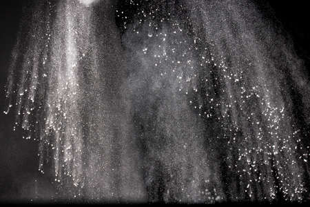 Abstract design of powder cloud against dark backgroundの写真素材