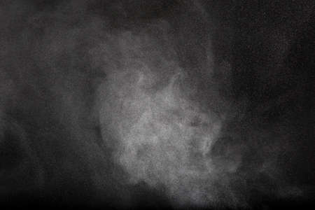 Abstract design of powder cloud against dark backgroundの写真素材