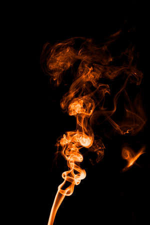 Orange smoke on a black background. Shot in studioの写真素材