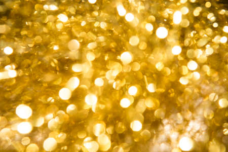 Christmas background and  golden abstract glitter defocused background with blurred bokeh.の写真素材