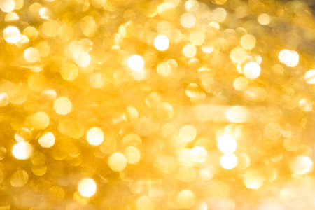 Christmas background and  golden abstract glitter defocused background with blurred bokeh.の写真素材