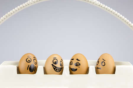 funny eggs with painted faces expressing different emotionsの写真素材