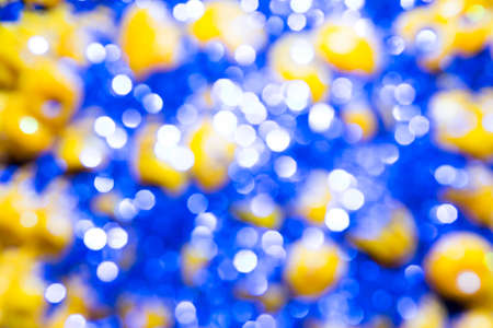 Blue bokeh texture. Festive glitter background with defocused lights.の写真素材